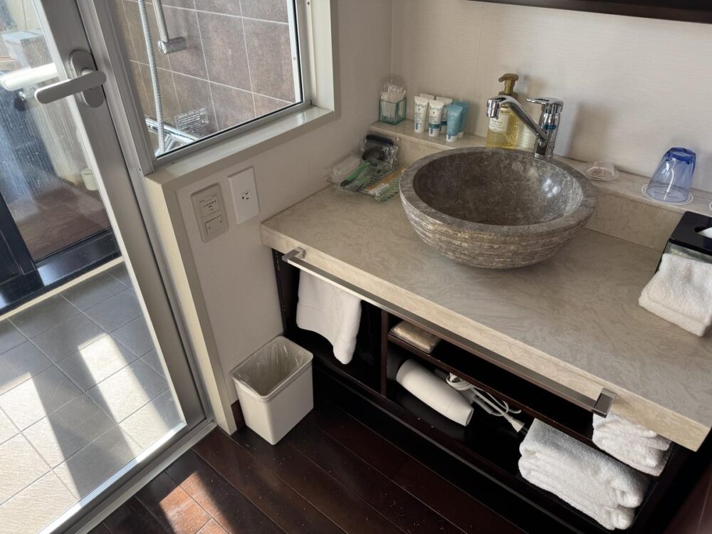 石の洗面鉢が特徴的な洗面スペース